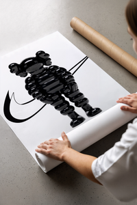 Black inflated cartoon companion figure print laid flat in a styling flatlay