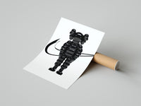 Black inflated cartoon companion figure poster styled above furniture in a modern room