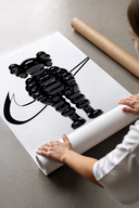Inflated black KAWS Companion figure print laid flat in a styling flatlay