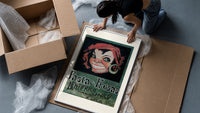 Grinning woman's face with earring framed print being unpacked from protective bubble wrap and a box