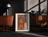 Black-framed Young girl in red nightgown print on a moody console with designer coffee-table books