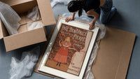 Young girl in red nightgown framed print being unpacked from protective bubble wrap and a box