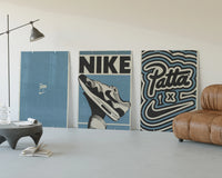 Patta x Nike Air Max 1 Blue Triptych displayed beside a brown leather sofa