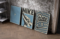 Patta x Nike Air Max 1 Blue Triptych as black-framed prints leaning against a raw-plaster wall