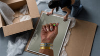Patterned Nails with Stacked Watches framed print being unpacked from protective bubble wrap and a box