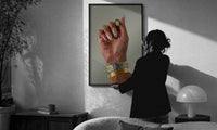 Patterned Nails with Stacked Watches print in a slim black frame being hung on a sunlit wall in a monochrome room