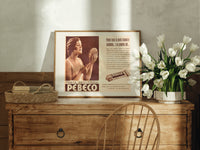 Woman holding hand mirror print in an oak frame on a farmhouse dresser beside white tulips