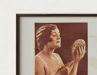 Close-up of the Woman holding hand mirror print's dark wood frame corner and archival matte paper