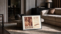 Woman holding hand mirror print in a slim black frame leaning on a travertine coffee table