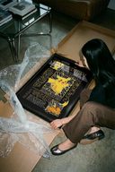 Person unrolling a Pichu Pikachu Raichu Pokemon Evolution art print with japanese text descriptions on smooth concrete floor