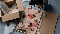 Pink Drink, Cherries and Perfume framed print being unpacked from protective bubble wrap and a box