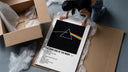 Pink Floyd Dark Side of the Moon Prism framed print being unboxed from protective packaging