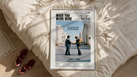 Pink Floyd Wish You Were Here Burning Handshake framed print styled on a bed with sneakers alongside