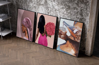 Pink Headscarf, Roses and Drink Set of 3 as black-framed prints leaning against a raw-plaster wall