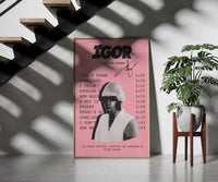 Pink Tyler the Creator IGOR Tracklist framed print on a staircase entryway wall beside a plant