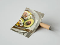 Gently curled Poached Eggs on Avocado Toast print beside its protective shipping tube