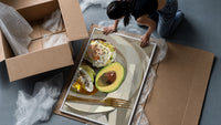 Poached Eggs on Avocado Toast framed print being unpacked from protective bubble wrap and a box