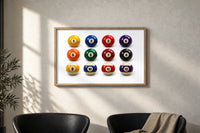 Twelve Pool Balls Solids and Stripes print in an oak frame on a sunlit wall above two leather armchairs