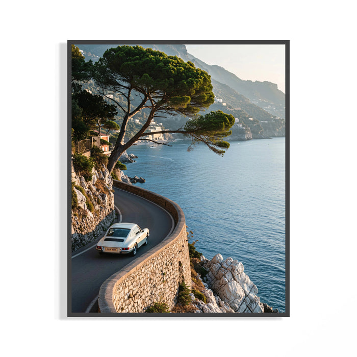 White Porsche 911 sports car cornering a winding Italian coastal road above azure Mediterranean water in a wall print