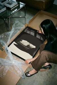 Porsche 911 Classic Front Noir poster being unrolled on a concrete floor