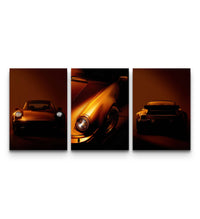 Three Porsche 911 prints showing front, side, and rear angles in dramatic orange tones on a white wall