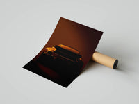 Rear Porsche 911 with whale-tail spoiler silhouetted in deep amber tones displayed as a rolled print