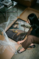 Woman unrolling a Porsche 911 Yellow Amalfi Coast Road - Luxury Sports Car Wall Art poster print on a concrete floor