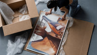Pouring a Sparkling Drink framed print being unpacked from protective bubble wrap and a box