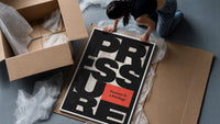 Pressure Is a Privilege framed print being unpacked from protective bubble wrap and a box