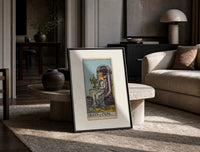 Queen seated on throne holding cup print in a black frame leaning on a travertine table in a sunlit lounge