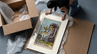 Queen seated on throne holding cup framed print being unpacked from protective bubble wrap and a box