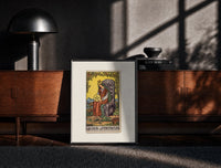 Black-framed Crowned queen holding pentacle on throne print on a moody console with designer coffee-table books