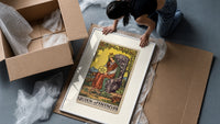 Crowned queen holding pentacle on throne framed print being unpacked from protective bubble wrap and a box