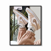 Framed Raised Legs in Beige Sneakers print shown as a bold statement piece on a clean gallery wall