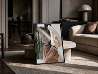 Raised Legs in Beige Sneakers print on the floor, leaning against a travertine table