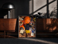 Black-framed Records, Books and a Basketball print on the floor in front of a dark wooden console