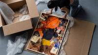 Records, Books and a Basketball framed print being unpacked from protective bubble wrap and a box