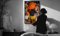 Records, Books and a Basketball print in a slim black frame being hung on a sunlit wall in a monochrome room