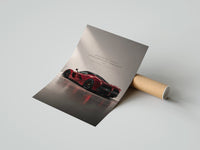 Gently curled Red Ferrari LaFerrari print beside its protective shipping tube