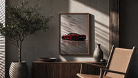 Red Ferrari LaFerrari poster framed above a fluted sideboard beside a potted tree