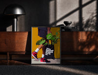 Black-framed Plant Tote and Red High-Tops print on the floor in front of a dark wooden console