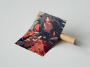 Rolled Anime warrior with red eyes poster beside its crush-resistant kraft shipping tube