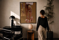 Red Platform Heels and Mesh Bag print in a black frame on a sunlit plaster wall, a woman looking on beside a mushroom lamp