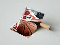Gently curled Red Sneakers on a Basketball print beside its protective shipping tube