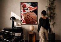 Red Sneakers on a Basketball print in a black frame on a sunlit wall with a viewer