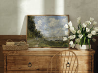 Riverside marina with sailboats print in an oak frame on a farmhouse dresser beside white tulips