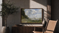 Riverside marina with sailboats print in a wood frame above a fluted sideboard beside an olive tree