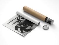 Rolled fashion print partly unrolled by a cardboard tube and cap on white showing the B&W croc boots detail