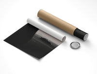 Partially unrolled Porsche 911 poster on white with a cardboard shipping tube and black cap resting alongside it