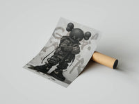 Rolled poster showing a black KAWS figure in a Nike bomber jacket on a grey graffiti backdrop beside a cardboard tube